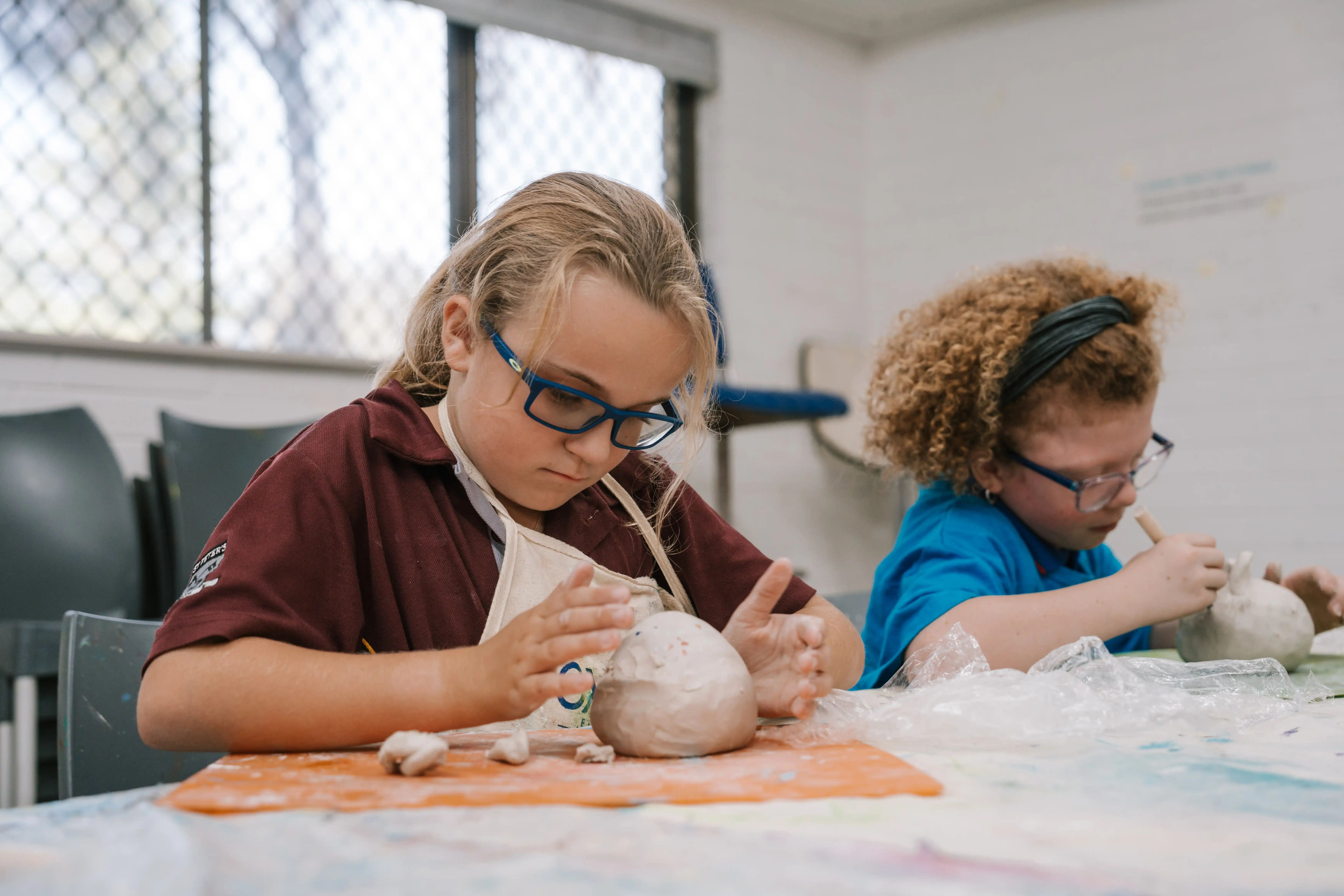 Kids creating sculptures in art class.